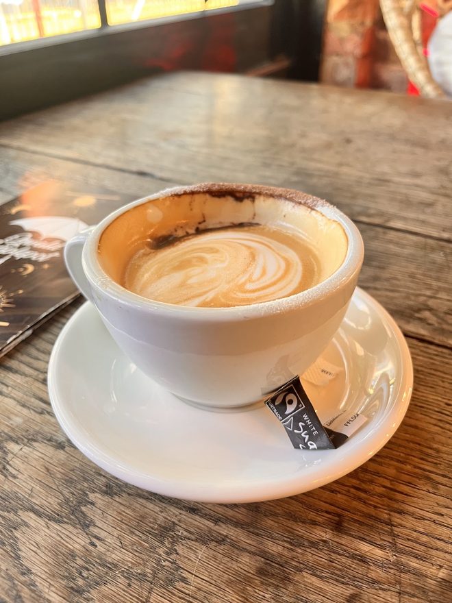 A flat white in warm window light